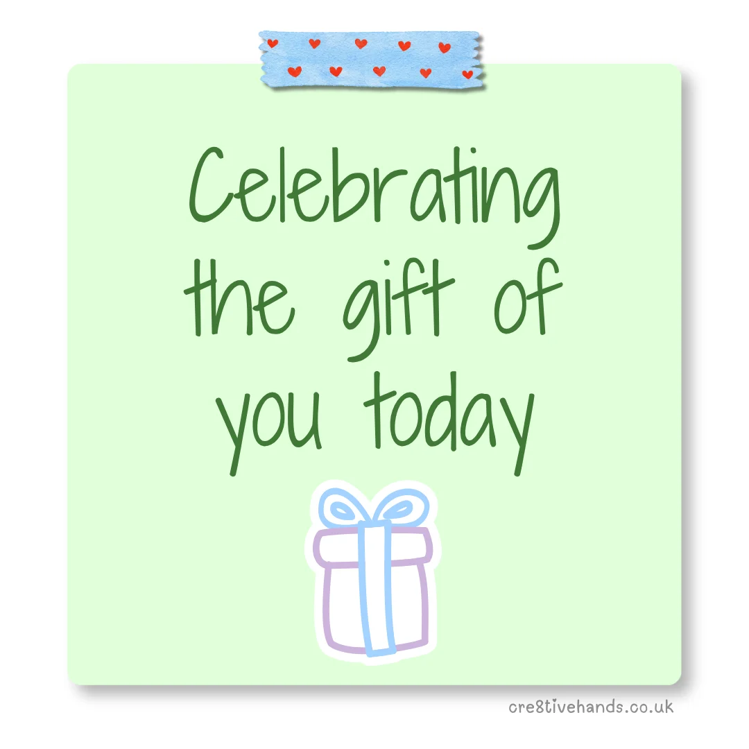 Pastel green sticky note with the message “Celebrating the gift of you today” with blue heart tape and a small gift doodle.