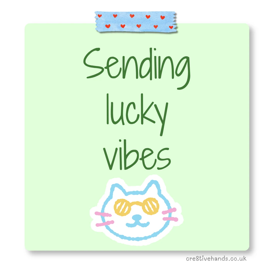Pastel green sticky note with the message “Sending lucky vibes” with blue heart tape and a cute cat face doodle.